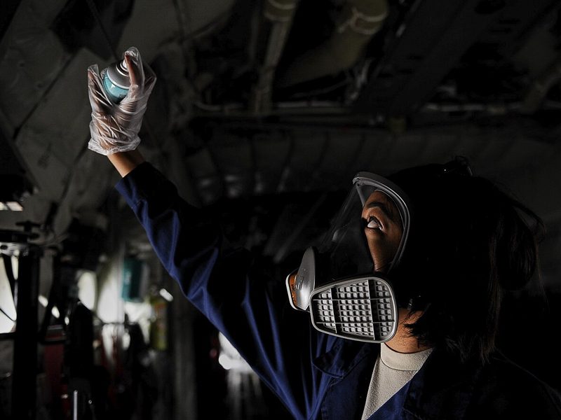 A pest control technician holding a sprayer