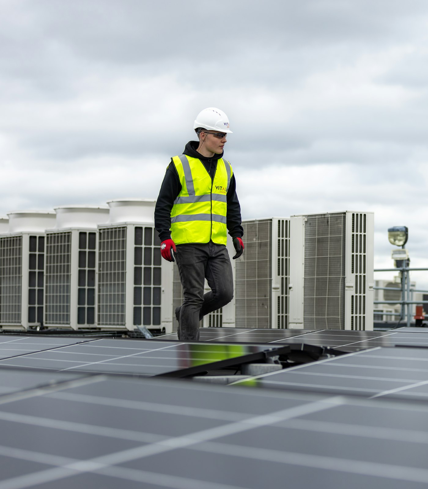 A technician testing an air conditioning unit with a handheld gauge